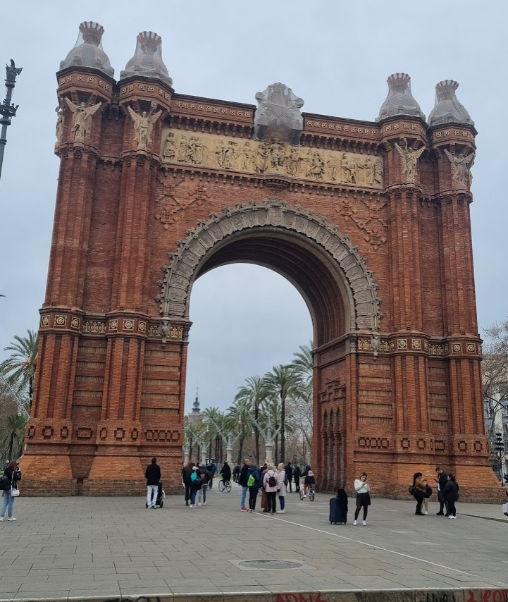 Picture of the iconic red brick Arc de Triomf monument in Barcelona, Spain, with its grand arches and intricate carvings on display