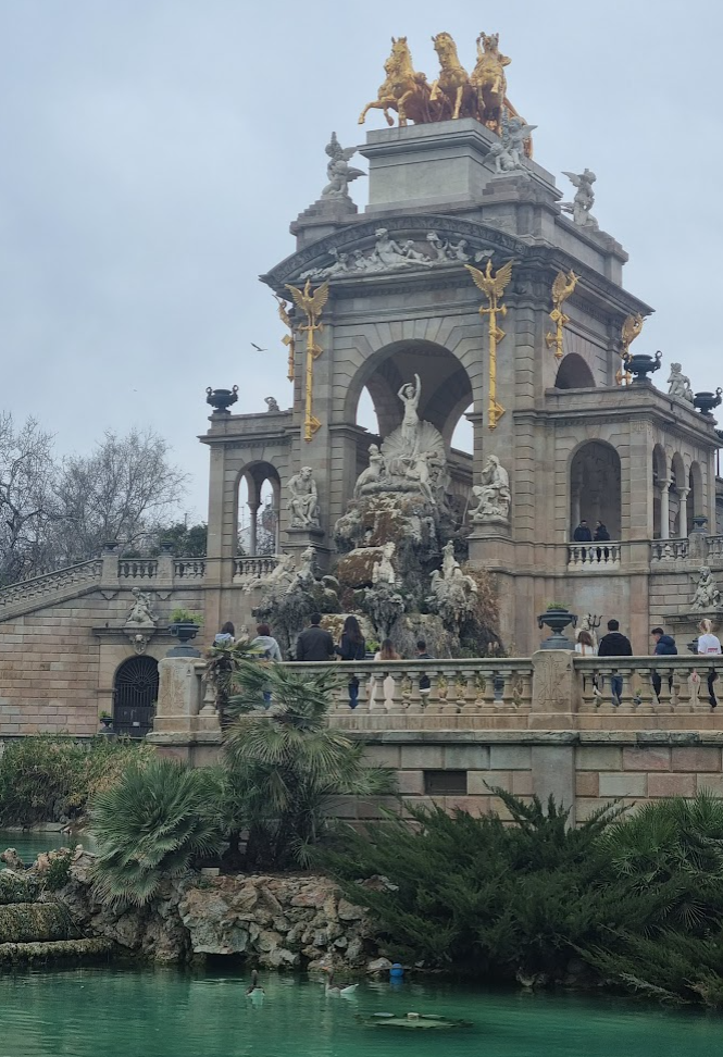 Picture of the cascading waterfalls in Ciutadella Park, surrounded by lush greenery and flowers